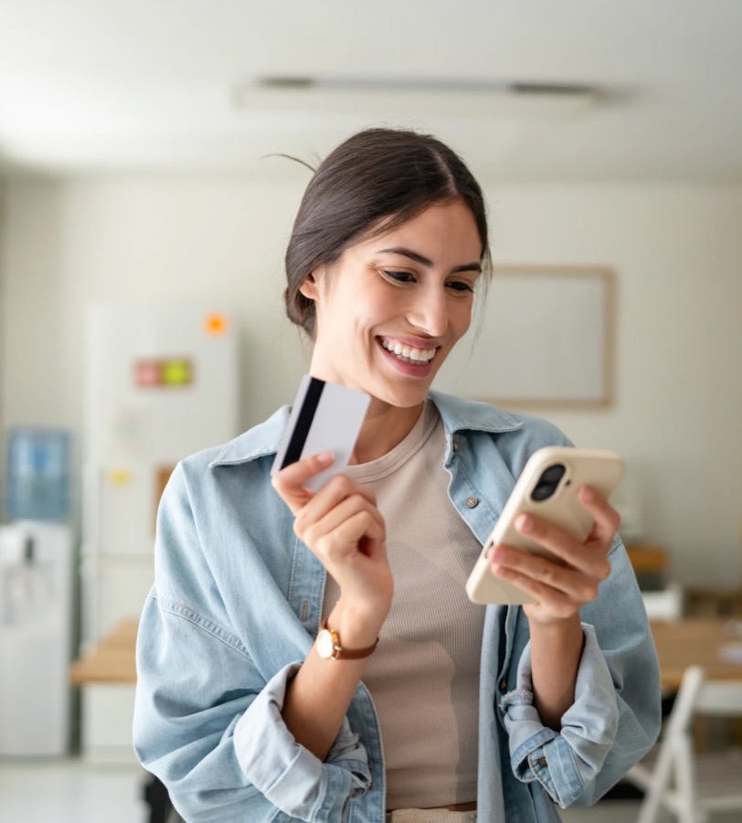 Smiling woman checking her credit on her phone